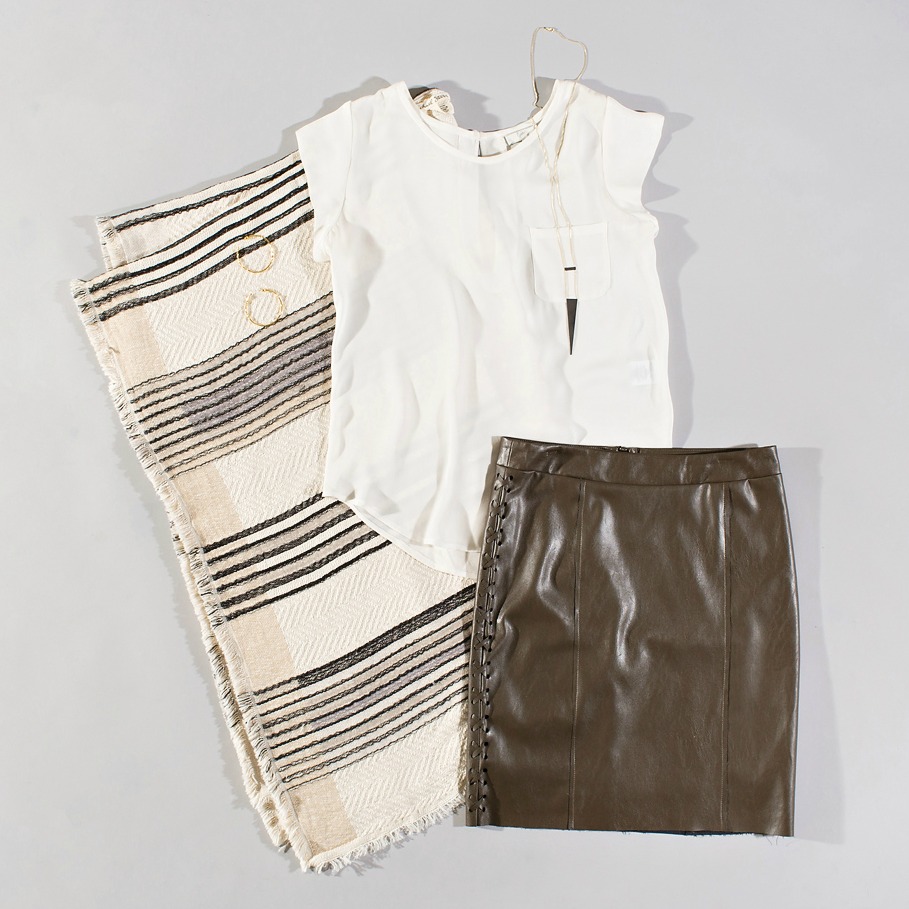 white silk top styled with a coco leather skirt and poncho